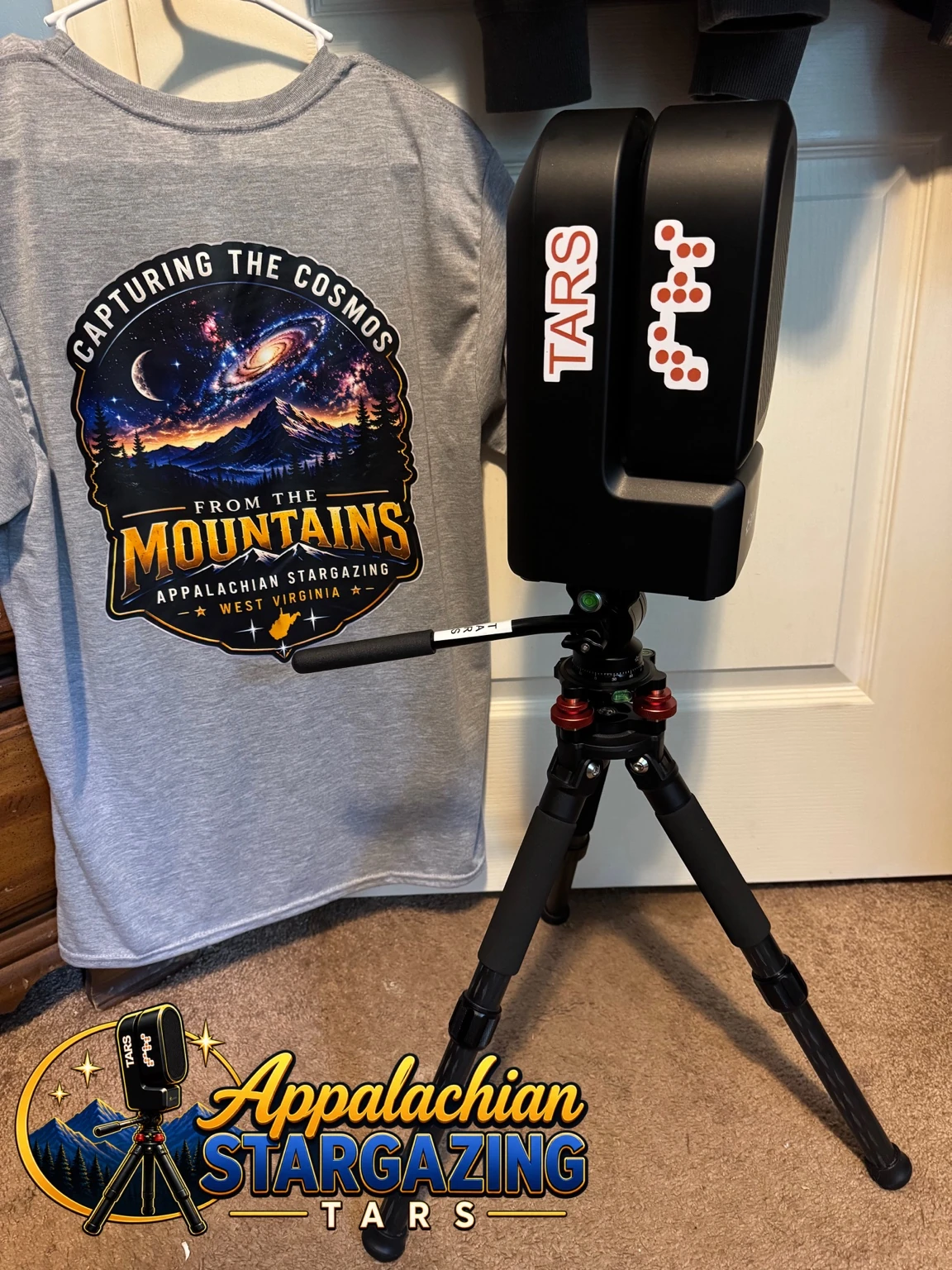 TARS, a black Seestar S50 with its name on the telescope, standing on a tripod beside an Appalachian Stargazing shirt